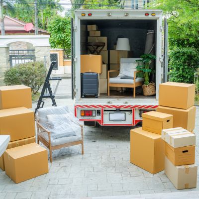 Image shows the back of an open rental truck surrounded by boxes